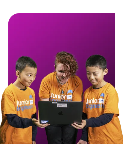 Junior Engineers instructor teaches coding to two young boys